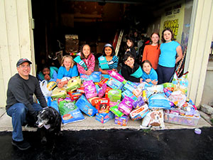 Girl Scout Troop 60026 with pet food collected for Mark & Willy (far left)